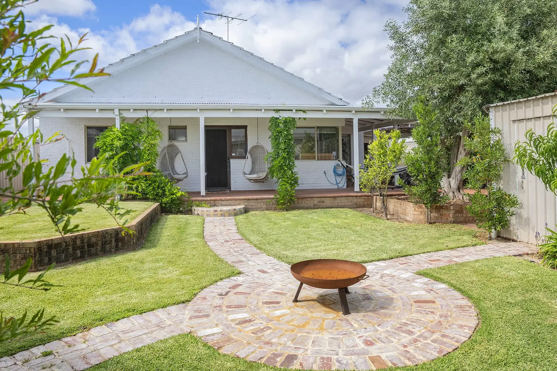 The front garden of the house, with a fire pit